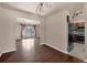 Open dining room featuring hardwood floors, modern lighting, and access to the kitchen and living spaces at 4643 S Vivian Ct, Morrison, CO 80465