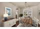 Charming dining area with hardwood floors, a rustic table, and bright natural light at 4643 S Vivian Ct, Morrison, CO 80465