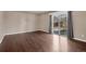 Hardwood flooring, a sliding glass door, and neutral decor in a minimalist living room at 4643 S Vivian Ct, Morrison, CO 80465