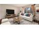 Stylized living room with a plush sofa, modern rug, and ample natural light at 4643 S Vivian Ct, Morrison, CO 80465