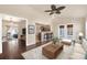 Spacious living room flowing into kitchen, with hardwood floors and natural light at 4643 S Vivian Ct, Morrison, CO 80465