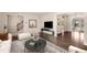 Bright living room with hardwood floors, neutral decor, and open layout to a naturally lit area at 4643 S Vivian Ct, Morrison, CO 80465