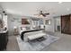 Bright main bedroom features a ceiling fan, art, seating and barn door to the ensuite bathroom at 4643 S Vivian Ct, Morrison, CO 80465