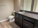 Modern bathroom with dark wood vanity, granite countertops, and tiled shower at 4280 E Warren Ave # 2, Denver, CO 80222