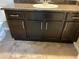 Bathroom vanity with dark cabinets, granite countertop, and a white ceramic sink at 4280 E Warren Ave # 2, Denver, CO 80222
