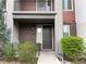 Inviting townhome entrance with modern accents, brickwork, and manicured greenery at 4280 E Warren Ave # 2, Denver, CO 80222