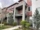 Charming modern townhome featuring private balconies, brick accents, and landscaped front yard at 4280 E Warren Ave # 2, Denver, CO 80222