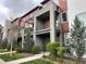 Charming modern townhome featuring private balconies, brick accents, and landscaped front yard at 4280 E Warren Ave # 2, Denver, CO 80222