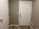 Hallway with wood-look flooring and white doors at 4280 E Warren Ave # 2, Denver, CO 80222