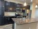 Modern kitchen features stainless steel appliances, granite countertops, and dark wood cabinets at 4280 E Warren Ave # 2, Denver, CO 80222
