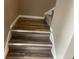 Staircase featuring hardwood steps and neutral walls at 4280 E Warren Ave # 2, Denver, CO 80222