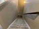 Carpeted stairway with handrail leading to the lower level at 4280 E Warren Ave # 2, Denver, CO 80222