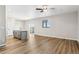 Open concept living space with wood floors, a ceiling fan, and sliding door access to the backyard at 17935 E 94Th Ave, Commerce City, CO 80022