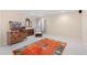 Finished basement area featuring a colorful rug, vintage furniture, and neutral walls, offering a versatile space at 5432 S Cathay Way, Centennial, CO 80015