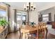 Dining room with hardwood floors, chandelier, curtains, and furniture at 5432 S Cathay Way, Centennial, CO 80015