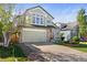 Charming two-story home with a well-manicured lawn, stone accents, and a two-car garage at 5432 S Cathay Way, Centennial, CO 80015