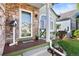 Inviting front porch with stone accents, a wooden deck, and a decorative birdhouse at 5432 S Cathay Way, Centennial, CO 80015