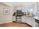 Charming kitchen features white cabinetry, stainless steel appliances, and hardwood floors at 5432 S Cathay Way, Centennial, CO 80015