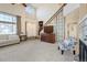 Bright living room with a two-story ceiling, large windows, and a staircase at 5432 S Cathay Way, Centennial, CO 80015