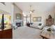 Bright living room with a fireplace, vaulted ceiling, and large windows at 5432 S Cathay Way, Centennial, CO 80015
