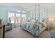 Light-filled main bedroom with a four-poster bed and scenic backyard views at 5432 S Cathay Way, Centennial, CO 80015