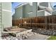 Side yard with garden bed, wooden fence, and decorative rocks at 5432 S Cathay Way, Centennial, CO 80015
