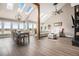 Bright living room featuring vaulted ceilings, exposed beams, skylights, and floor-to-ceiling windows with beautiful scenic views at 7786 Windwood Way, Parker, CO 80134