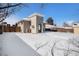 Snowy backyard with a modern home and wooden fence at 2930 N Fillmore St, Denver, CO 80205