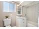 Clean basement bathroom with a white vanity, shower/tub combo, and tile flooring at 2930 N Fillmore St, Denver, CO 80205