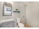 Updated bathroom with gray vanity and walk-in shower at 2930 N Fillmore St, Denver, CO 80205