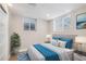 Basement bedroom with gray headboard and blue bedding at 2930 N Fillmore St, Denver, CO 80205