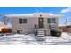 Charming ranch home with snowy front yard and landscaping at 2930 N Fillmore St, Denver, CO 80205