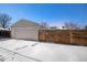 Detached garage with new wooden fence in snowy setting at 2930 N Fillmore St, Denver, CO 80205