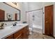 Updated bathroom features dark wood cabinets, white countertops, and modern shower with tub at 17313 W 43Rd Dr, Golden, CO 80403