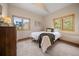 Cozy bedroom featuring two windows showcasing the green hillside and a glimpse of the neighborhood at 17313 W 43Rd Dr, Golden, CO 80403