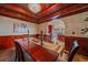Traditional dining room with wood trim, a chandelier and view into the kitchen at 17313 W 43Rd Dr, Golden, CO 80403