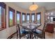 Inviting dining room boasts scenic views, dark wood accents, and comfortable seating for four at 17313 W 43Rd Dr, Golden, CO 80403