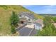 Stunning two-story home with attached garages and solar panels, nestled against a picturesque hillside at 17313 W 43Rd Dr, Golden, CO 80403