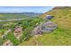 Spacious home on a hillside featuring an open rooftop deck with a fire pit, surrounded by lush greenery at 17313 W 43Rd Dr, Golden, CO 80403