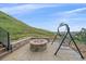 Outdoor patio with a fire pit, porch swing and stunning views at 17313 W 43Rd Dr, Golden, CO 80403