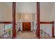 Elegant two-story foyer featuring a tile floor, grand chandelier, and large wooden double doors at 17313 W 43Rd Dr, Golden, CO 80403