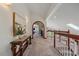 Bright hallway with a wooden staircase and elegant decor, leading to comfortable living spaces at 17313 W 43Rd Dr, Golden, CO 80403
