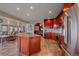 Open kitchen showcases island with seating, and stainless appliances, seamlessly connecting to the living space at 17313 W 43Rd Dr, Golden, CO 80403