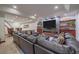 Open living room boasts a sleek fireplace, a large TV, and luxurious leather seating at 17313 W 43Rd Dr, Golden, CO 80403
