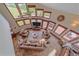 Spacious living room with tile floor, multiple windows, ceiling fan, and comfortable seating arrangement at 17313 W 43Rd Dr, Golden, CO 80403