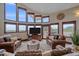 Comfortable living area with large windows, leather seating, and an entertainment center at 17313 W 43Rd Dr, Golden, CO 80403