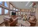 Expansive living room with fireplace, abundant windows, comfortable seating, and lovely views at 17313 W 43Rd Dr, Golden, CO 80403