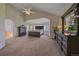 Spacious main bedroom featuring a vaulted ceiling and a seating area with stunning natural light at 17313 W 43Rd Dr, Golden, CO 80403