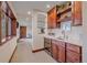 Elegant wet bar with a wine fridge, sink, and hardwood cabinetry at 17313 W 43Rd Dr, Golden, CO 80403