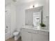 Bright bathroom features a combination tub and shower, white vanity, and a large mirror for a clean, modern look at 1815 N Williams St, Denver, CO 80218